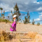 Photo of  beautiful young woman in a hat at sea resort